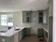 New kitchen featuring green cabinets, quartz countertops, and a large island at 200 Saunter Ct # 30, Johns Island, SC 29455