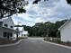 Quiet tree-lined road with white buildings on either side at 200 Saunter Ct # 30, Johns Island, SC 29455