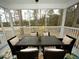 Relaxing screened porch with a wooden table and wicker chairs at 420 Eagleview Dr, Moncks Corner, SC 29461
