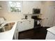 White kitchen cabinets, stainless steel appliances, and dark hardwood floors at 420 Eagleview Dr, Moncks Corner, SC 29461