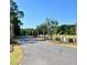 Landscaped entrance to the community with paved roads and mature trees at 1069 Capersview Ct, Awendaw, SC 29429