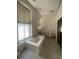 Bathroom with a bathtub, toilet, and large window at 354 King St St # B, Charleston, SC 29401
