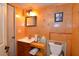 Small bathroom with wood paneling and single sink vanity at 717 Central Ave, Summerville, SC 29483