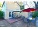 Relaxing backyard patio with table, chairs, and umbrellas at 717 Central Ave, Summerville, SC 29483
