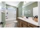 Modern bathroom with green walls, wood vanity, and white shower/tub at 4000 Middleton Dr, Goose Creek, SC 29445