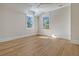 Spacious bedroom with hardwood floors and two large windows at 19 Bradley Pasture Way, Ravenel, SC 29470