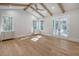 Main bedroom with hardwood floors, vaulted ceiling, and private access to balcony at 19 Bradley Pasture Way, Ravenel, SC 29470