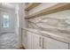 Butler's pantry with marble countertops and wooden shelves at 19 Bradley Pasture Way, Ravenel, SC 29470