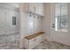 Mudroom with built-in bench, hooks, and herringbone tile floor at 19 Bradley Pasture Way, Ravenel, SC 29470