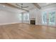 Spacious living room with hardwood floors, fireplace, and French doors at 19 Bradley Pasture Way, Ravenel, SC 29470