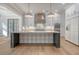 Bright kitchen features white cabinets, marble backsplash, and a spacious island at 19 Bradley Pasture Way, Ravenel, SC 29470