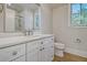 Modern bathroom with white vanity, quartz countertop and walk-in shower at 19 Bradley Pasture Way, Ravenel, SC 29470