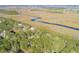 Aerial view of waterfront homes nestled amongst marsh and waterways at 1619 Zurlo Way, Johns Island, SC 29455