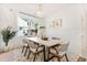 Bright dining room with wood table, wicker chairs, and large window at 1458 Tangles Trl, Charleston, SC 29492