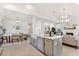 Open kitchen with large island, white cabinets, and stainless steel appliances at 1458 Tangles Trl, Charleston, SC 29492