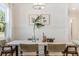 Bright dining room with wood table, wicker chairs, and board and batten wall at 1458 Tangles Trl, Charleston, SC 29492