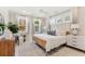 Spacious primary bedroom with wood bed frame and large windows at 1458 Tangles Trl, Charleston, SC 29492
