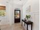 Bright entryway with dark brown door, wood flooring, and wainscoting at 1458 Tangles Trl, Charleston, SC 29492