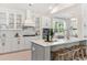 Modern kitchen with white cabinets, large island, and stainless steel appliances at 1458 Tangles Trl, Charleston, SC 29492