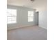 Bedroom with neutral carpeting, windows, and access to hallway at 1165 Oak Bluff Ave, Charleston, SC 29492