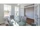 Sunlit dining room with glass table and French doors leading to an office at 1165 Oak Bluff Ave, Charleston, SC 29492