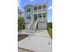 Two story light teal house with white accents and stairs at 1165 Oak Bluff Ave, Charleston, SC 29492