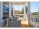 Relaxing front porch with two gray chairs and white railings at 1165 Oak Bluff Ave, Charleston, SC 29492