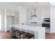 Eat-in kitchen boasts a large island, white cabinets, stainless steel appliances, and hardwood floors at 1165 Oak Bluff Ave, Charleston, SC 29492