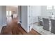 Bright dining room with hardwood floors and glass-top table, adjacent to kitchen at 1165 Oak Bluff Ave, Charleston, SC 29492