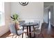 Charming dining room with round table, wicker chairs, and hardwood floors at 1165 Oak Bluff Ave, Charleston, SC 29492