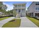 Two-story house with front porch, driveway, and partial view of the backyard at 1466 Tangles Trl, Charleston, SC 29492