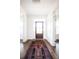 Bright entryway with hardwood floors, white wainscoting, and an ornate rug at 1466 Tangles Trl, Charleston, SC 29492