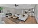 Open living area with L-shaped sofa, wood floors, and kitchen views at 1466 Tangles Trl, Charleston, SC 29492