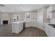Bright and modern kitchen with white cabinets, marble backsplash, and stainless steel dishwasher at 1466 Tangles Trl, Charleston, SC 29492