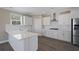 Bright kitchen with white cabinets, stainless steel appliances, and quartz countertops with a tile backsplash at 1466 Tangles Trl, Charleston, SC 29492