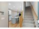 Entryway with staircase and view into a modern kitchen at 81 Sandbar Ln # 23, Folly Beach, SC 29439