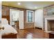 Spacious bedroom with hardwood floors, exposed brick wall, and built-in wardrobe at 29 Broad St # C, Charleston, SC 29401