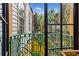 Charming balcony overlooks lush courtyard with tropical plants and neighboring buildings at 29 Broad St # C, Charleston, SC 29401