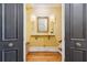 Bright entryway with a tasteful antique mirror and a wooden staircase at 29 Broad St # C, Charleston, SC 29401