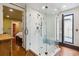 Bathroom with glass enclosed shower, and access to private balcony at 29 Broad St # C, Charleston, SC 29401