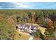 Luxury home with metal roof surrounded by colorful trees at 3820 Gnarled Oaks Ln, Johns Island, SC 29455
