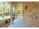 Covered back porch with brick exterior and columns at 3820 Gnarled Oaks Ln, Johns Island, SC 29455