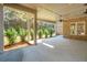 Covered porch with ceiling fan, brick wall, and lush greenery at 3820 Gnarled Oaks Ln, Johns Island, SC 29455