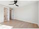 Empty bedroom with hardwood floors, ceiling fan, and open doorway to bathroom at 3820 Gnarled Oaks Ln, Johns Island, SC 29455