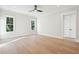 Empty bedroom with light hardwood floors, a ceiling fan, and large windows at 3820 Gnarled Oaks Ln, Johns Island, SC 29455