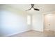 Empty bedroom with hardwood floors, a ceiling fan, and a window at 3820 Gnarled Oaks Ln, Johns Island, SC 29455
