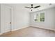 Bright, empty bedroom with hardwood floors, ceiling fan, and large windows at 3820 Gnarled Oaks Ln, Johns Island, SC 29455