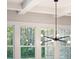 Stylish chandelier hanging from the coffered ceiling in a sunlit room at 3820 Gnarled Oaks Ln, Johns Island, SC 29455