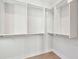 Large walk-in closet with white built-in shelves and hanging rods at 3820 Gnarled Oaks Ln, Johns Island, SC 29455