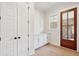 Entryway with white closet, built-in drawers, and a wooden door at 3820 Gnarled Oaks Ln, Johns Island, SC 29455